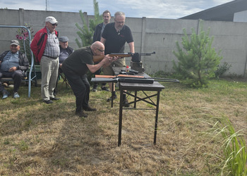 Zdjęcie przedstawia uczestników Klubu Seniora podczas zajęć na strzelnicy